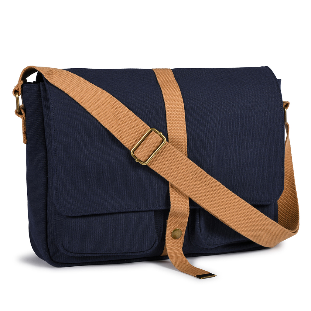 in canvas polycotton material with vintage looking. Two open pockets under front part which closes by a metal button. Compartment with zipper fastener